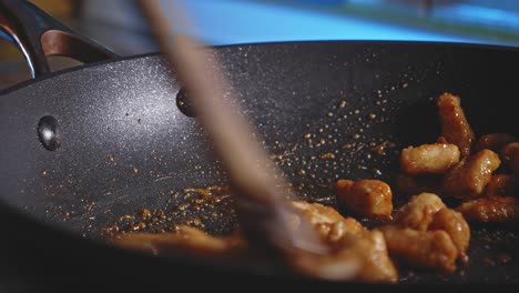 stir frying bits of chicken breast mix with soy sauce, honey, and garlic powder