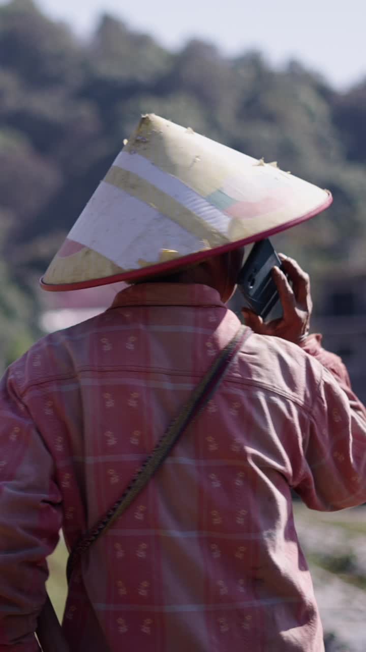 Woman in traditional Asian conical hat