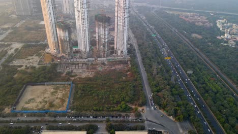 aerial drone shot capturing a massive construction site along the highway in noida gurgaon india
