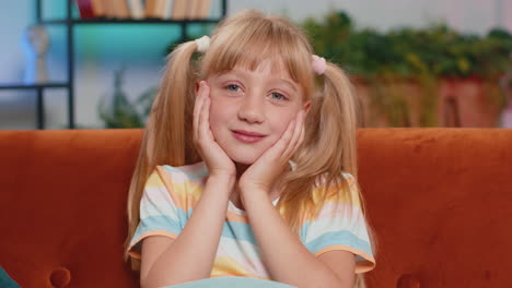 portrait of happy smiling caucasian preteen school girl child kid looking at camera home play room