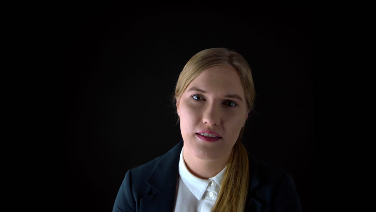 Potrait shot of young businesswoman looking into camera and talking in slow motion