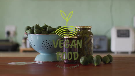 vegan food locally grown animation over fresh vegetables and jars on kitchen counter