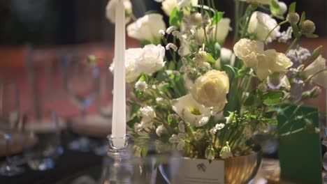 a table with a candle and flowers on it