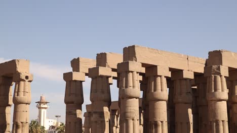 panning shot of the ancient columns of luxor temple in the center of the city