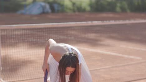 female tennis player practicing serve on outdoor court