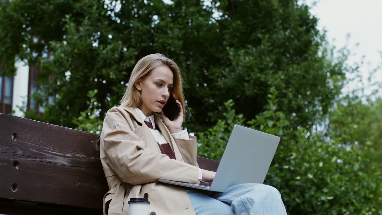 Young woman working outdoors on laptop