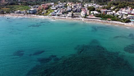 crystal clear sea water and small cozy township, aerial view