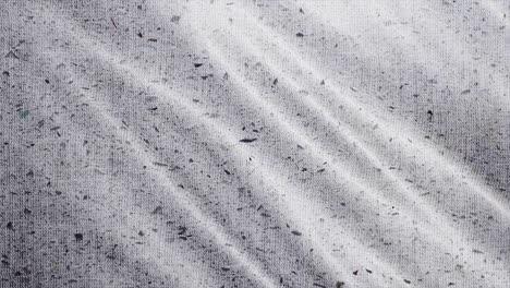 spotted fabric cloth close up shot. black dots on white background, monochrome pattern.