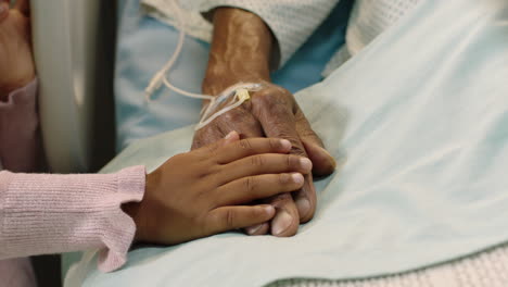 little-girl-touching-hand-of-grandfather-lying-in-hospital-bed-child-showing-affection-at-bedside-for-grandparent-recovering-from-illness-health-care-family-support