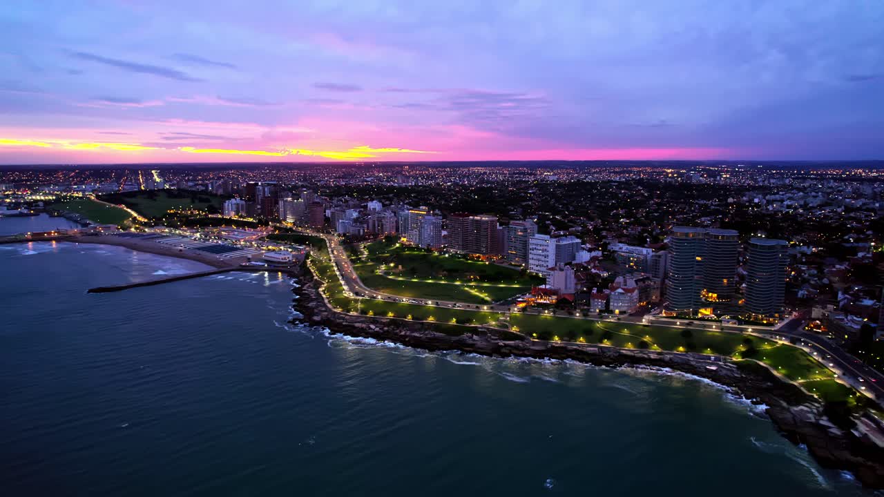 Rising Panoramic Aerial over Mar Del Plata City Waterfront at Vibrant Sunset