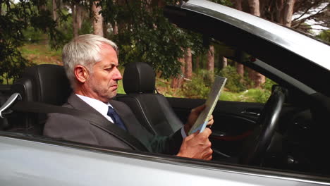 Businessman-in-a-silver-car