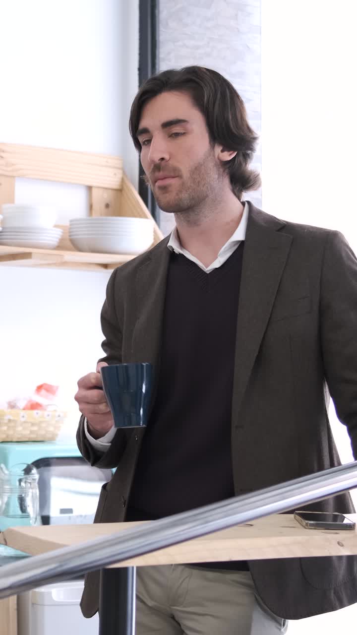 Businessman drinking coffee and speaking. Vertical footage