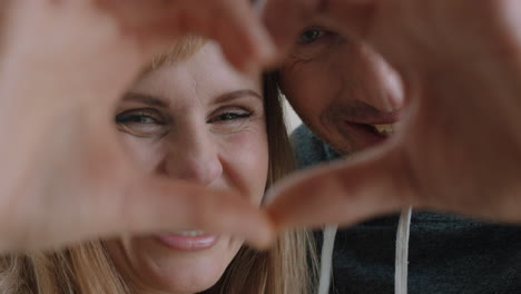 happy-couple-making-heart-shape-with-hands-gesturing-romantic-commitment-enjoying-loving-relationship-on-valentines-day-4k-footage