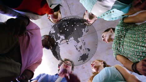 animation of globe over business colleagues standing in circle