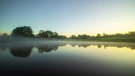 detached house and a reflecting lake, foggy autumn morning on the countryside