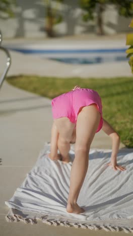 woman doing yoga outdoors near a swimming pool