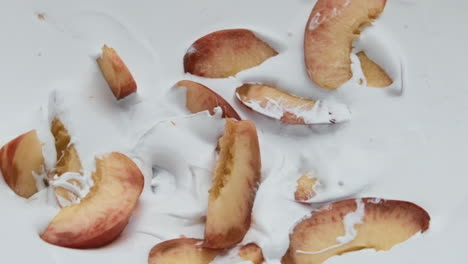 ripe peach pieces yogurt close up background. organic natural fruity milkshake.