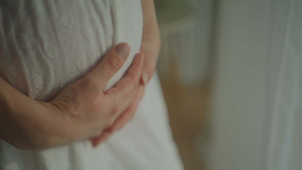 Close-up of Pregnant Woman's Hands on Belly