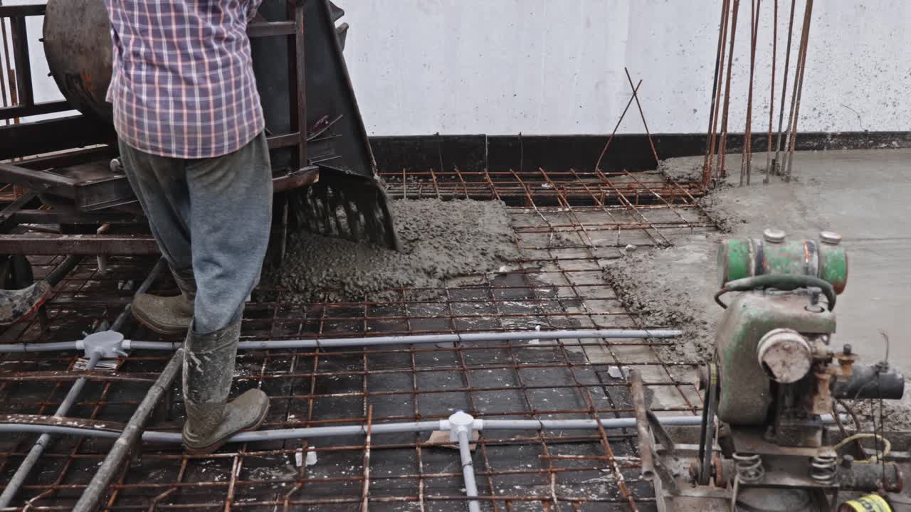 Worker Pouring M20 grade Concrete on Reinforcement Steel with under slab electric work at Construction Site. day time, stable shot, 4k