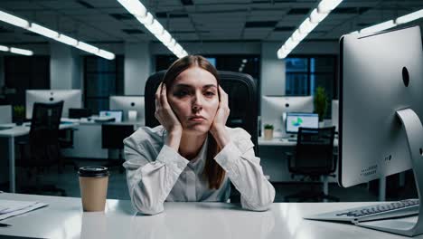 professional businesswoman experiencing workplace stress, sitting at desk and covering ears, overwhelmed by work pressure and mental exhaustion in corporate office environment