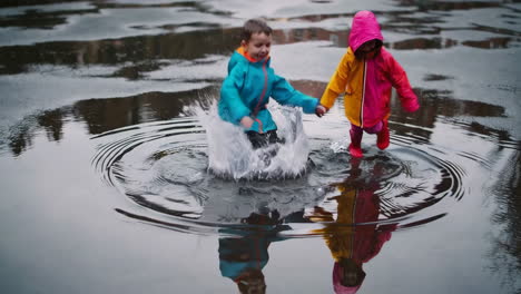 happy children splashing in puddles