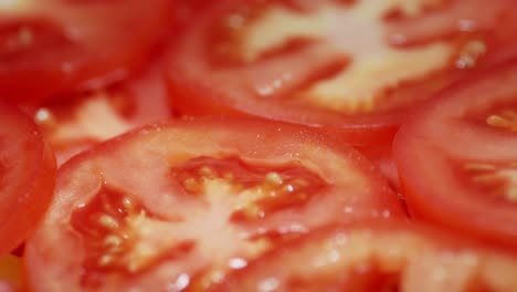 round slices of ripe tomato rotate slowly.
