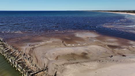 La-Gente-Camina-Frente-A-Los-Restos-Del-Puente-Que-Una-Vez-Estuvo-Con-Pilas-De-Piedra-Y-Madera-Sobre-El-Mar-Báltico