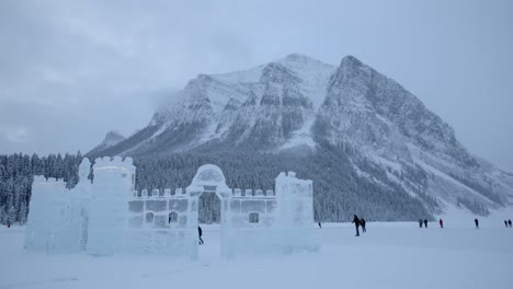 Landscape-Shot-of-Ice-Skaters-on-Lake-Louise,-Banff-National-Park,-Winter-Wonderland,-4K