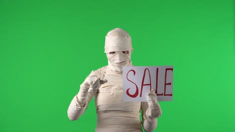 Mummy Character Holding 'SALE' Sign and Gesturing on Green Screen