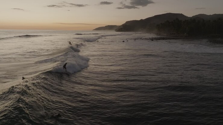 Aerial Drone view of surfers at Sunset El Zonte El Salvador