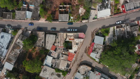 Aerial-birds-eye-overhead-top-down-ascending-footage-of-street-intersection-in-small-town-or-poor-suburban.-Valladolid,-Mexico