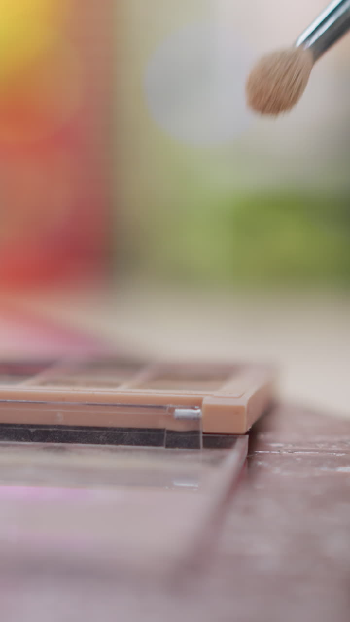 Soft focus image showcasing beauty products, Captivating close shot of makeup brushes and pigments, Detailed presentation of cosmetic tools with pastel shades for marketing and promotional content