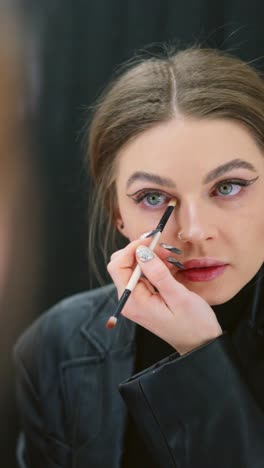 woman applying eye makeup