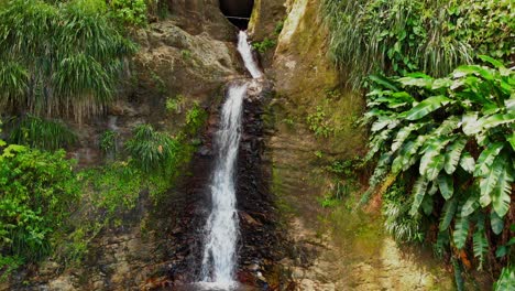 A-drone-ascending-showing-an-epic-waterfall-from-the-pool-at-the-bottom-to-the-source-at-the-top-on-the-Caribbean-island-of-Grenada