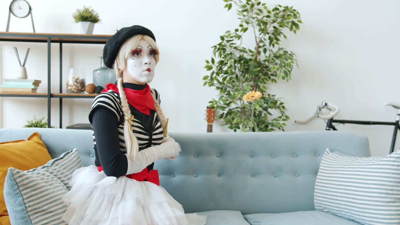 Mime Artists Interacting on a Sofa