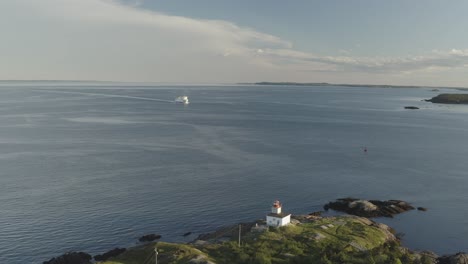 drone down with ferry and lighthouse in view