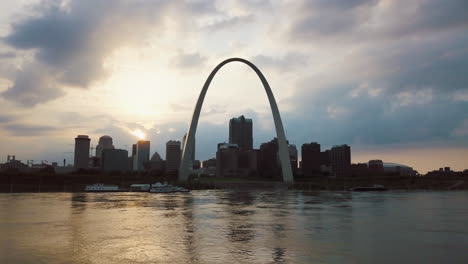 parallax drone shot over river of gateway arch in st