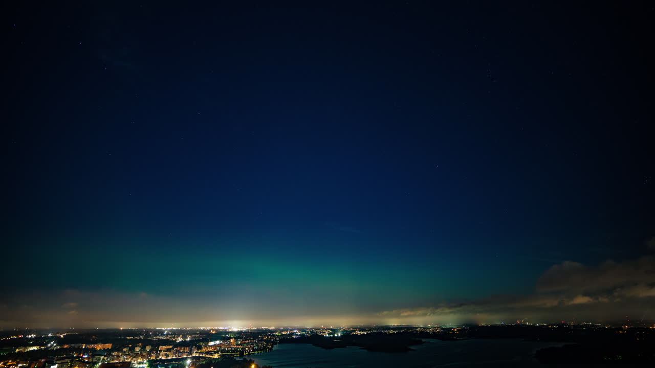 Aurora Borealis over a City at Night