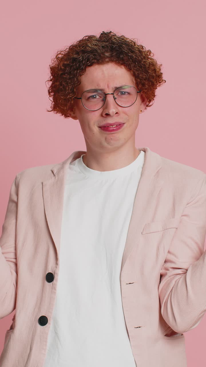 Caucasian man trying hear you looking confused and frowning keeping arm near ear for louder voice