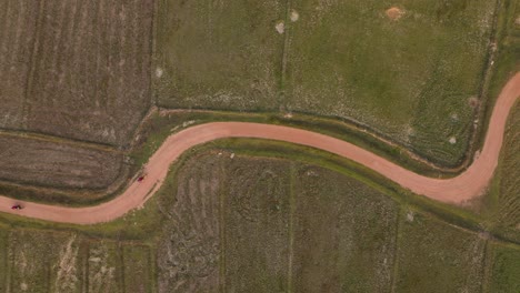 4K-aerial-drone-footage-of-a-curvy-road-in-Thailand,-Koh-Yao-Noi-Island,-rice-fields,-Asia,-motorbike,-scooter,-ride