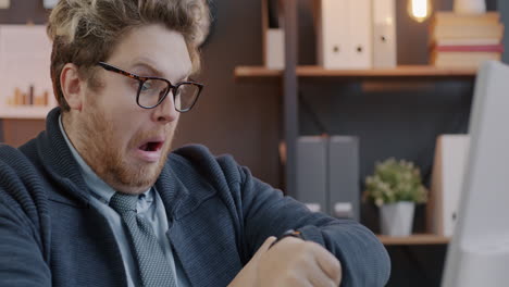 surprised business man checking watch in office