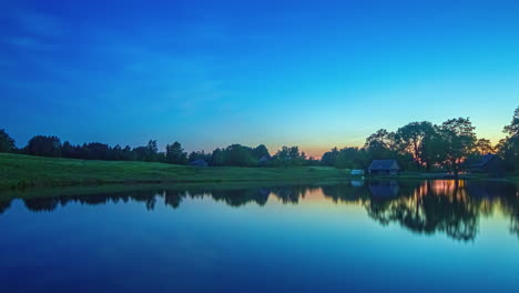 sunrise over a lake with country houses and cottages