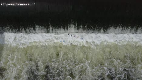 a rushing river of water is polluted with garbage