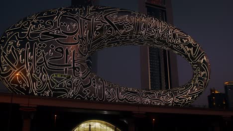 illuminated art sculpture in a cityscape at night