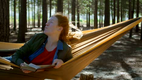 woman reading a book in the forest 4k