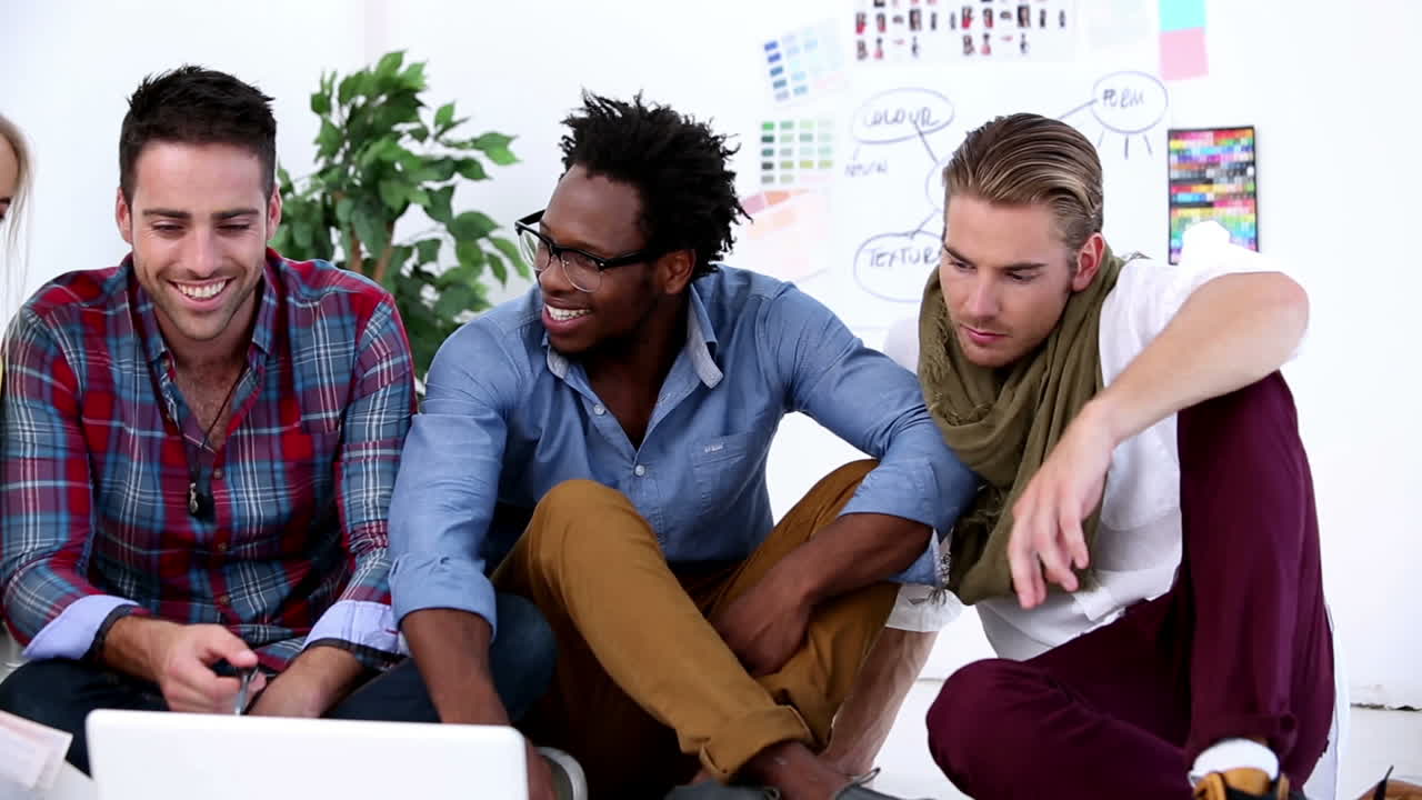 Colleagues working together on laptop