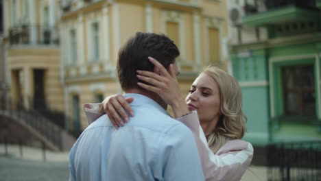 lovely couple hugging in at street. man and woman standing together outdoors