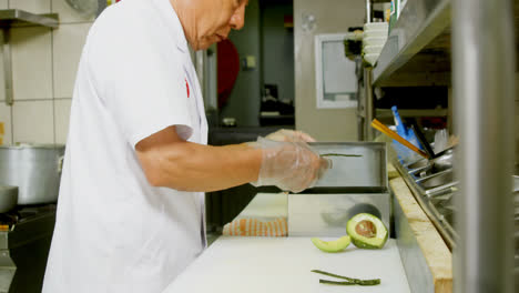 male chef placing nori on counter top in kitchen 4k