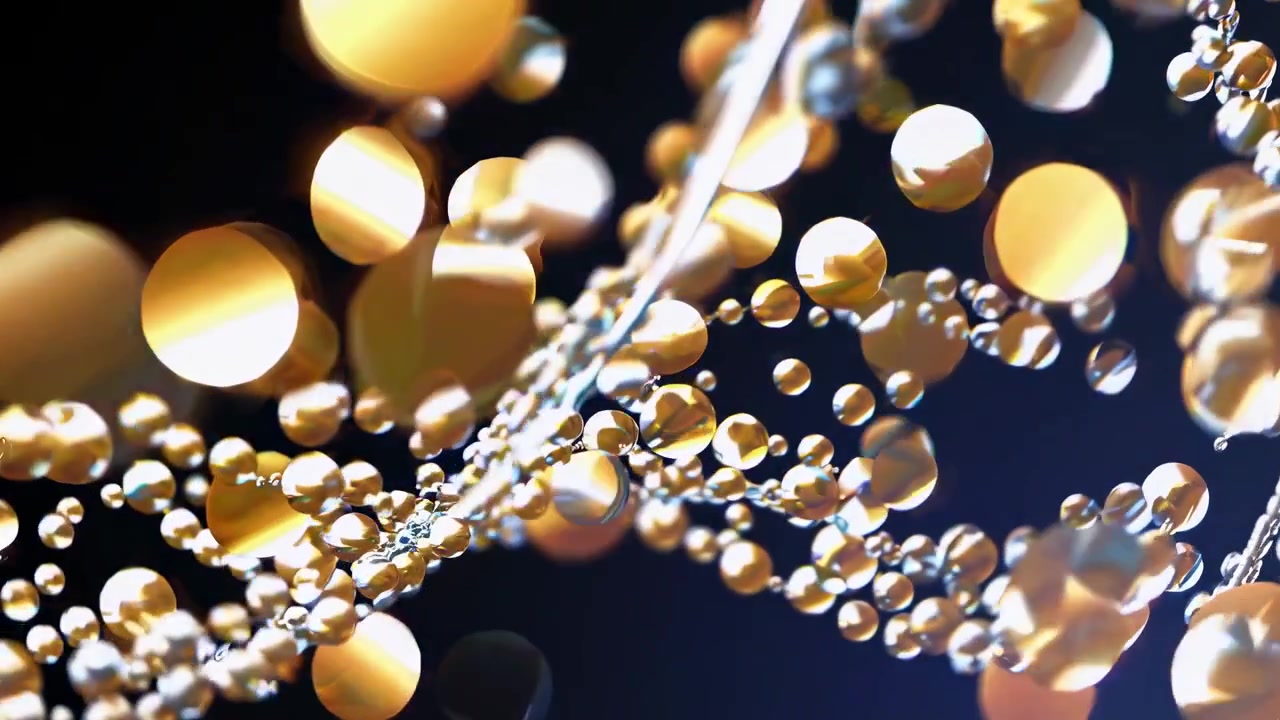 Movimento astratto di sfere dorate e argentate fluttuanti