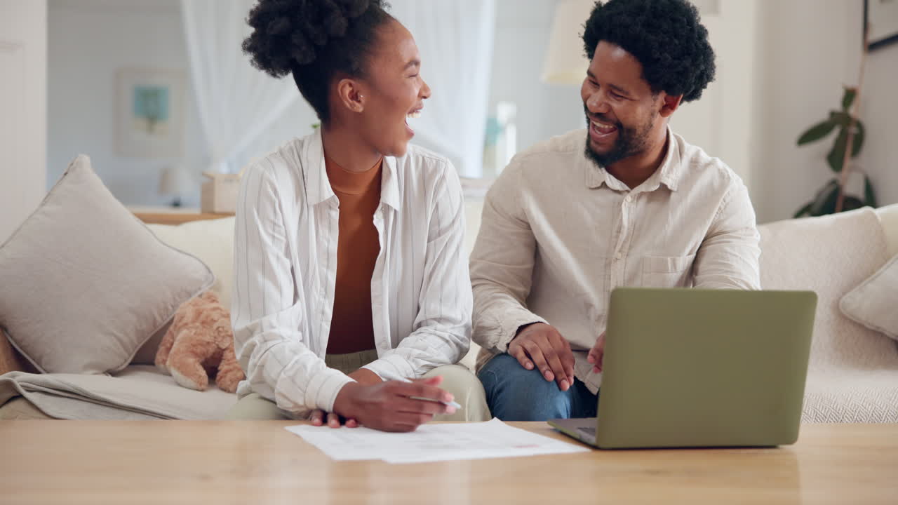 Happy couple working on laptop at home